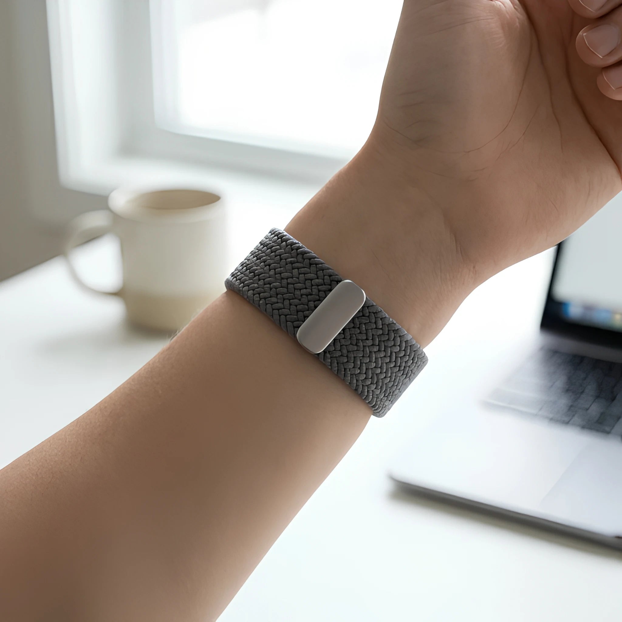 LoopBand worn on wrist with laptop and coffee